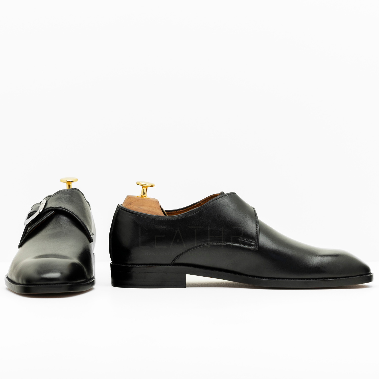 Pair of black leather shoes on a white background