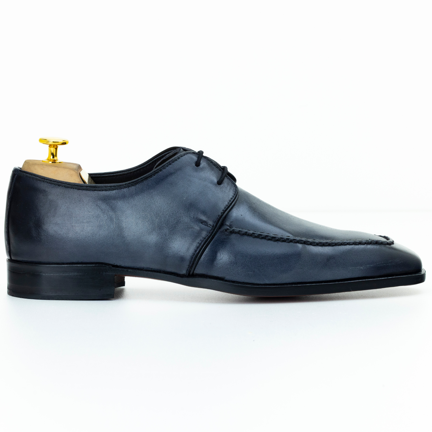 Blue leather dress shoe on a white background