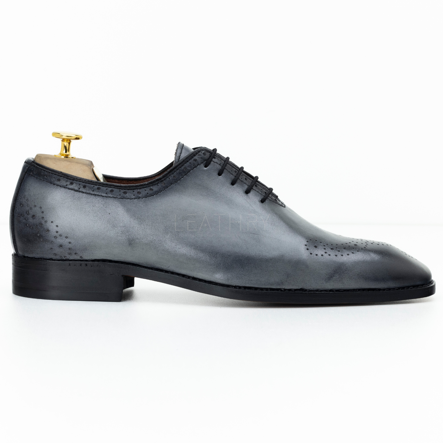 Gray leather dress shoe on a white background