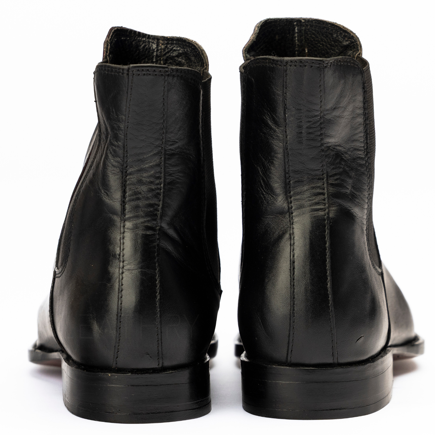 Pair of black leather boots on a white background