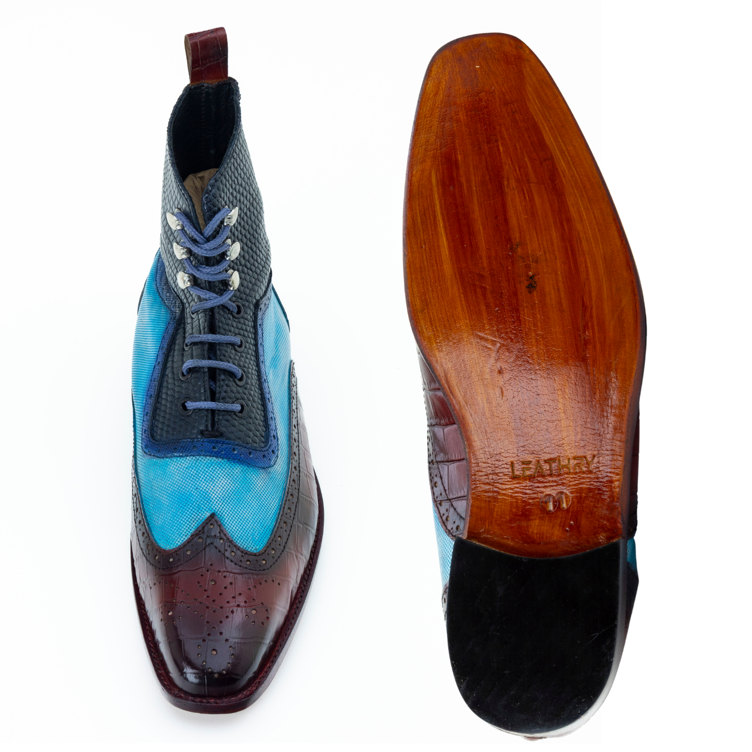Blue and brown wingtip shoe with wooden sole on a white background
