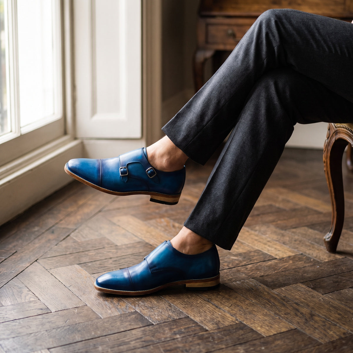 The Alton men's double monk strap shoe in blue calf leather with patina finish, styled editorial photo
