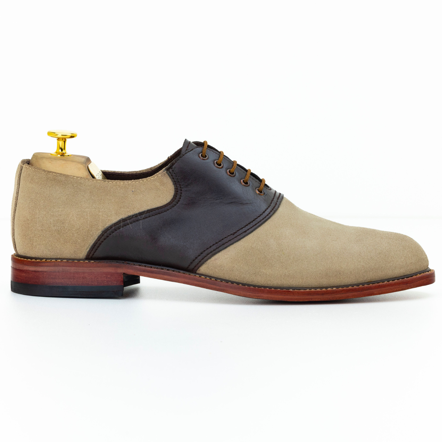 Beige and brown leather shoe on a white background