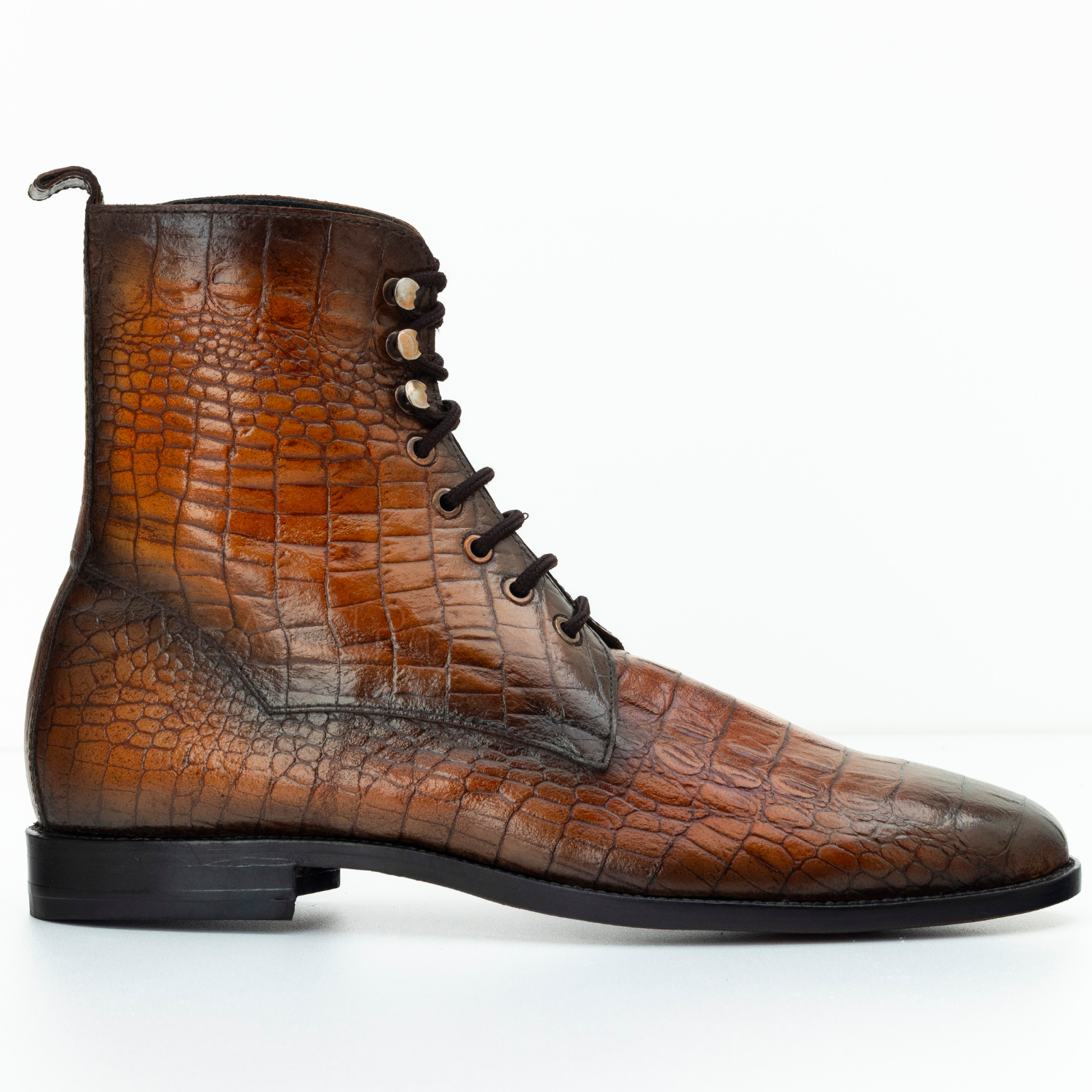 Brown leather boot with crocodile texture on a white background