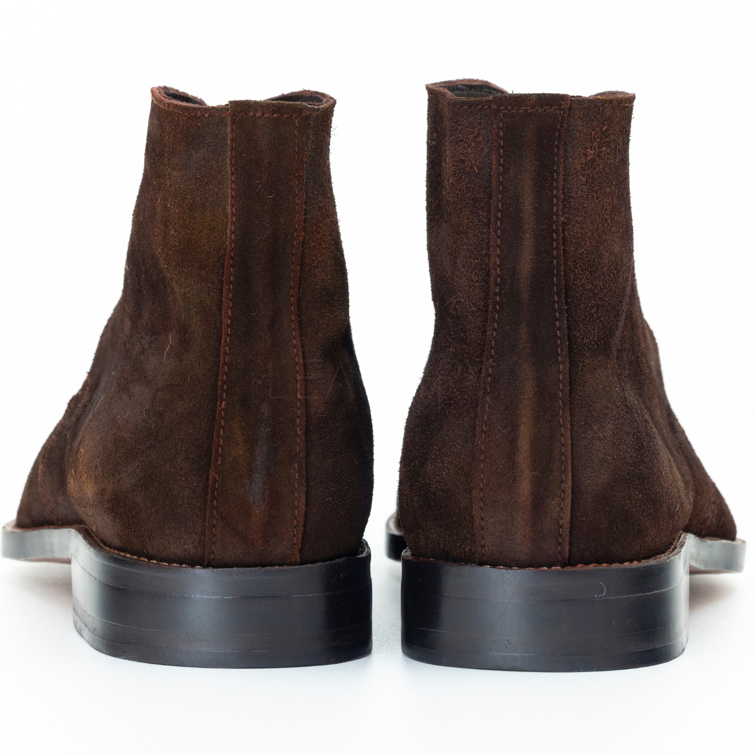 Pair of brown suede boots on a white background