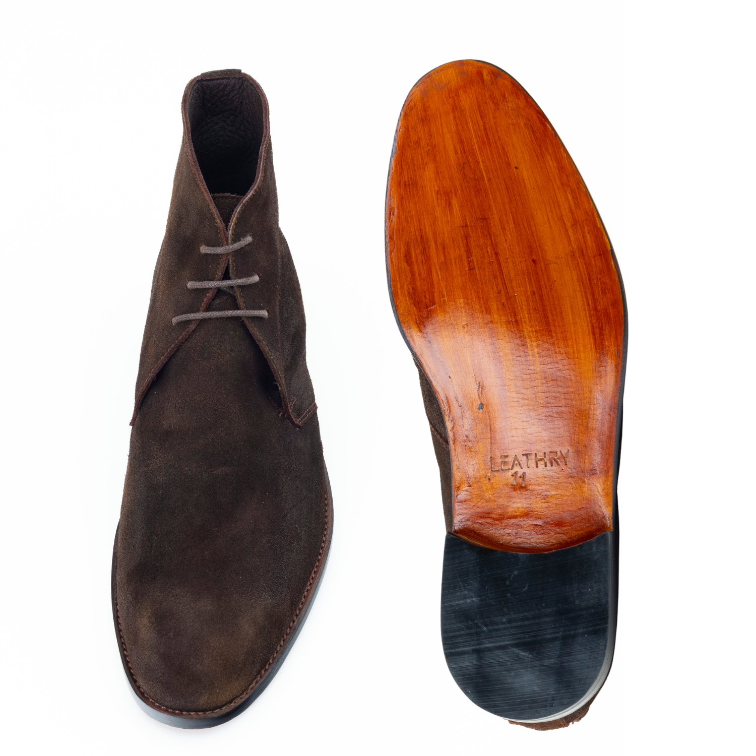 Brown suede shoe with wooden sole on a white background