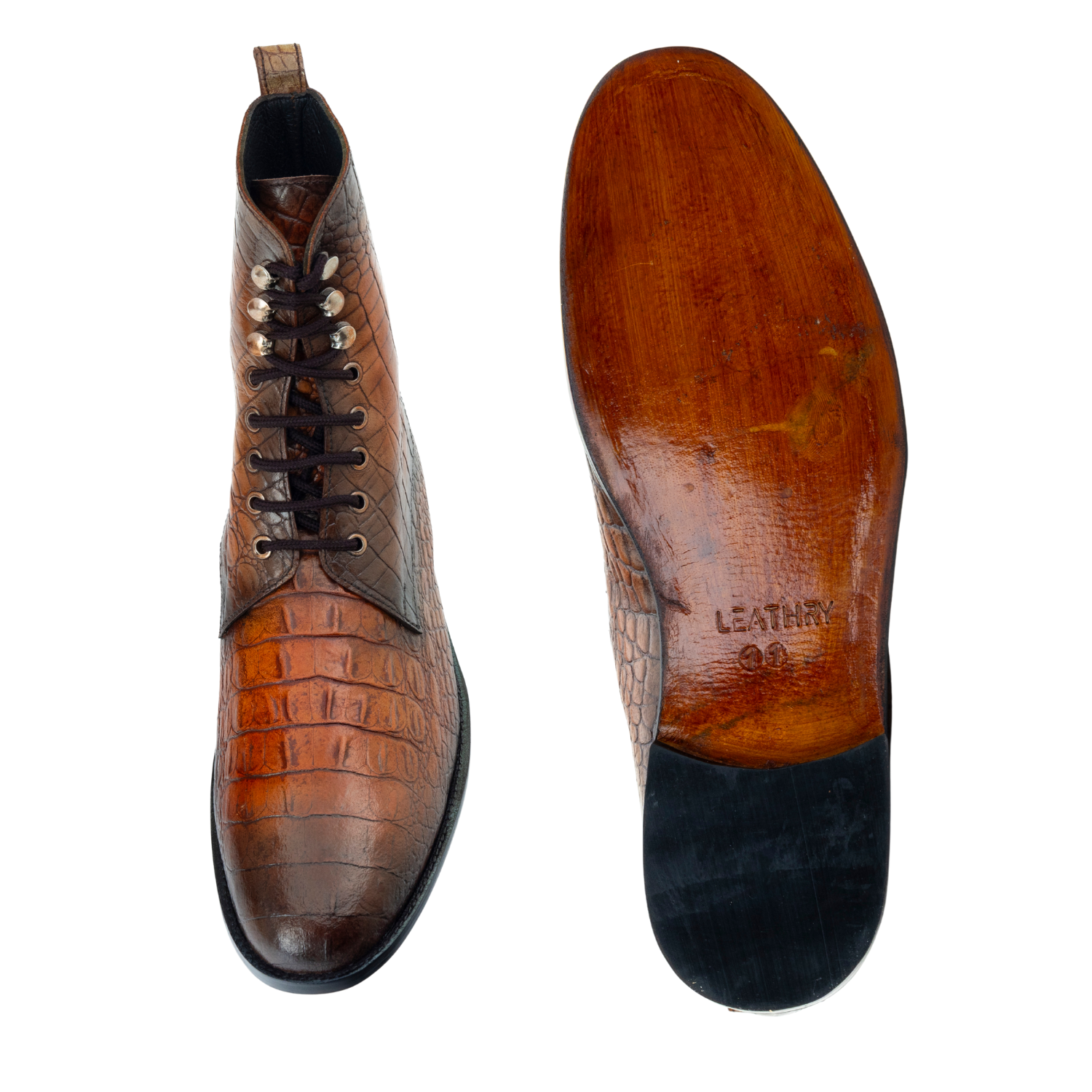 Brown leather shoe with crocodile pattern on a white background