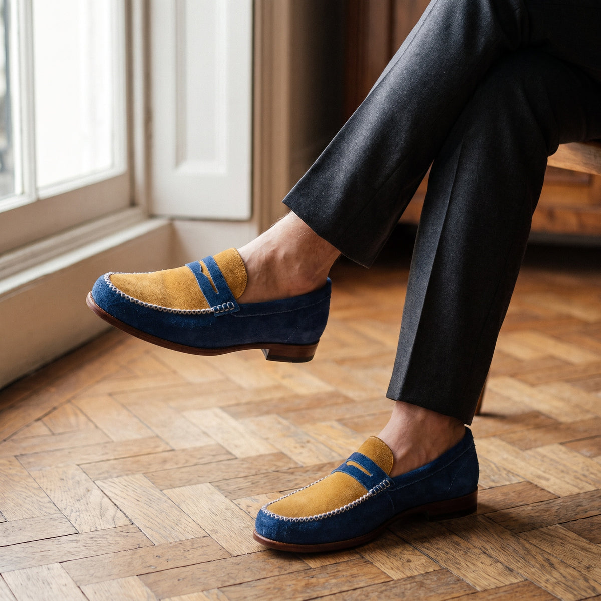The Abbott men's penny loafer in blue suede, styled editorial photo