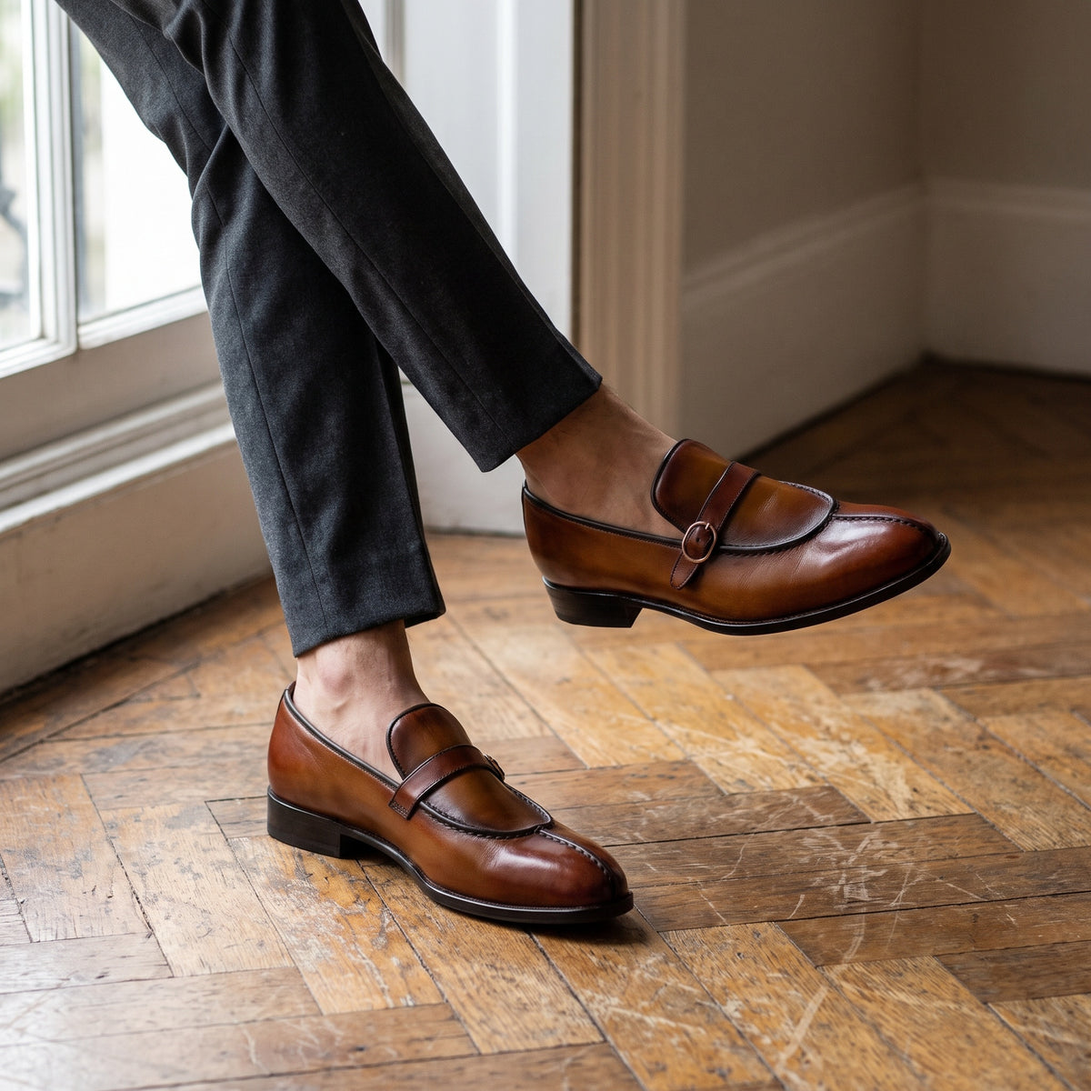 The Boone men's buckle loafer in tan brown calf leather with patina finish, styled editorial photo