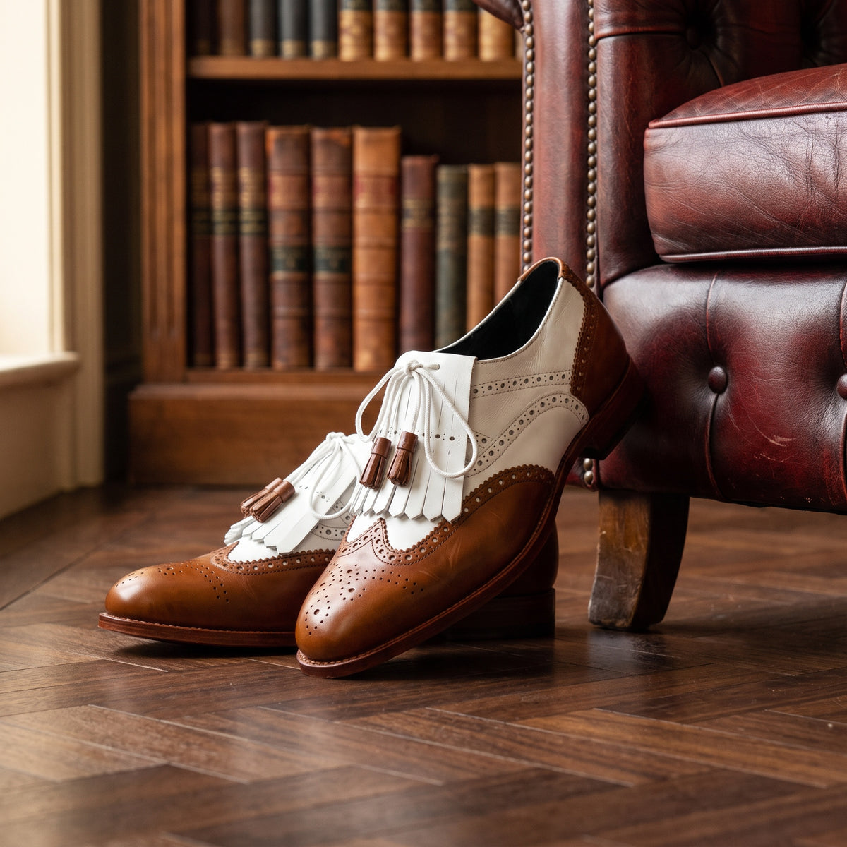 The Rowe men's wingtip Oxford shoe in brown and white calf leather, styled editorial photo
